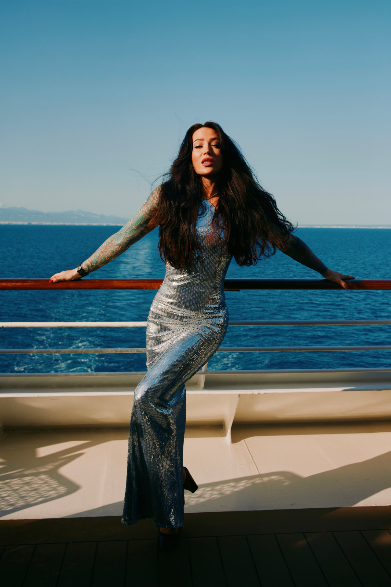Von Wager in a silver sequin gown, photographed at sea
